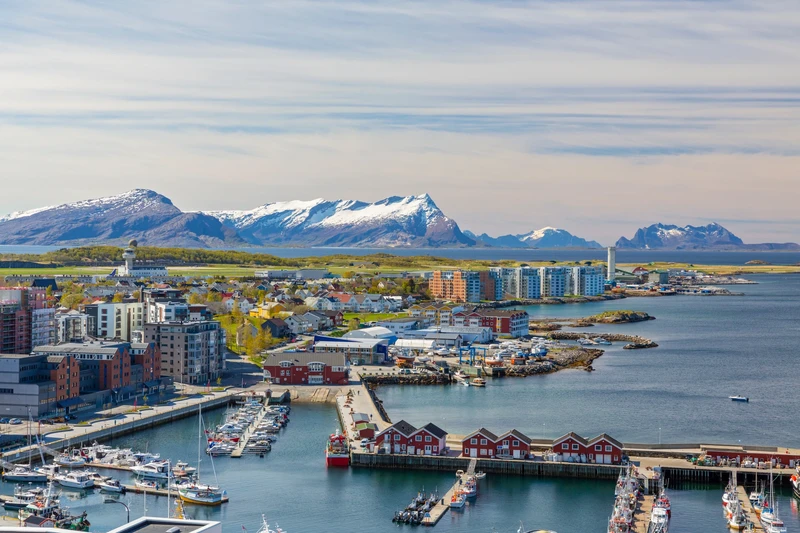 Bodø harbour with snow-capped mountains behind